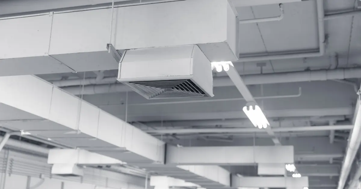 Exposed commercial ductwork and diffusers across a facility ceiling