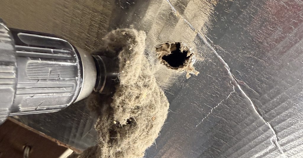 Drill-powered auger pulling lint from a dryer duct in Greater Sudbury