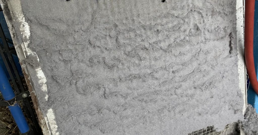Dust-caked filter pulled during an air duct cleaning in Greater Sudbury