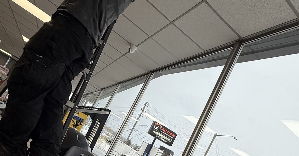 Greater Sudbury Duct Cleaning technician working above the ceiling at a Sudbury storefront