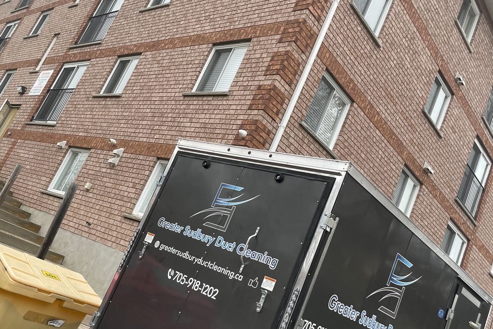 Greater Sudbury Duct Cleaning trailer at a multi-unit apartment building in Sudbury
