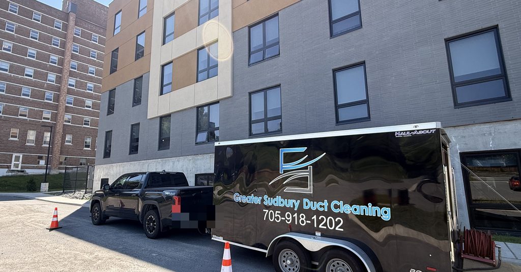 Greater Sudbury Duct Cleaning truck and trailer on site at a Sudbury apartment building