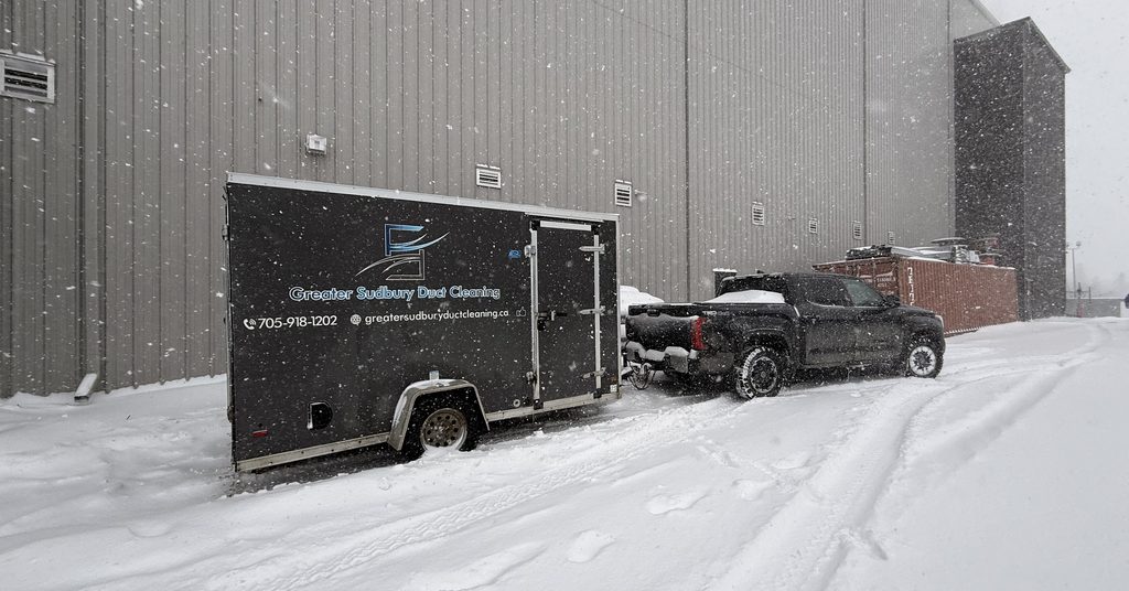 Greater Sudbury Duct Cleaning truck and trailer at an industrial building in winter